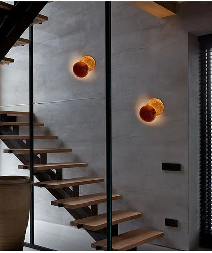 Modern staircase with wall lights in a stylish interior setting.