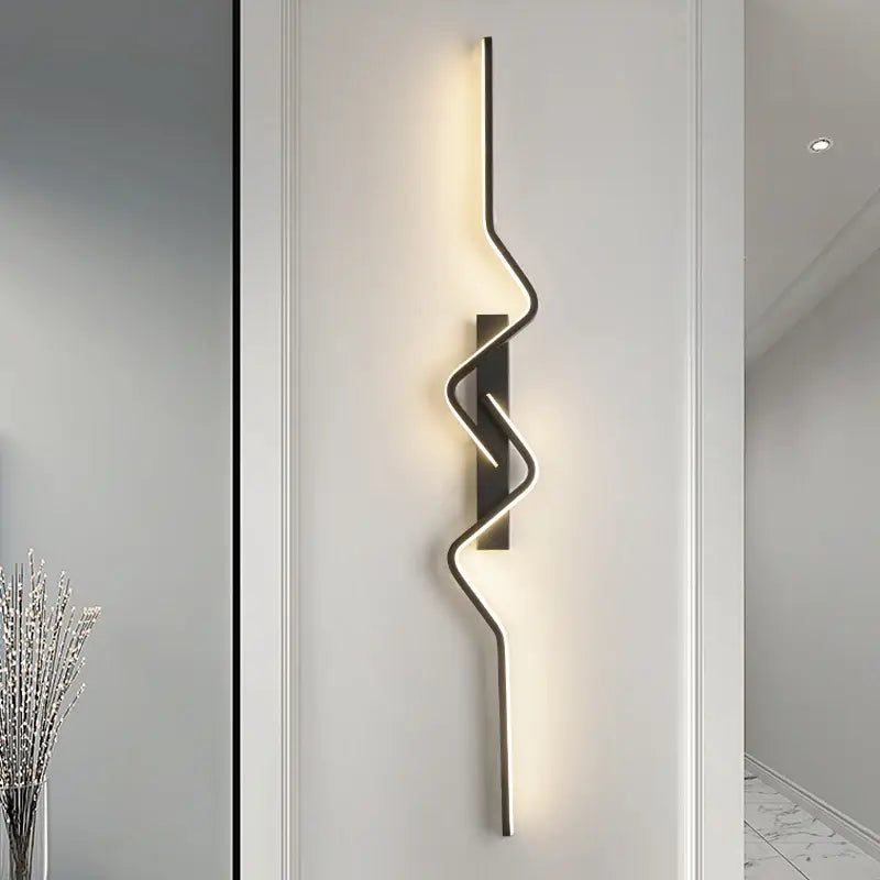 Modern wall lamp with a wavy design on a white wall.