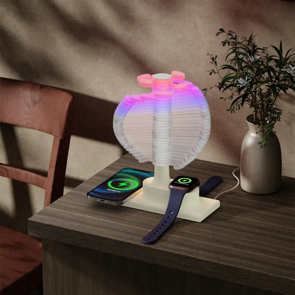 Multicolored LED lamp on a wooden table with a phone and a smartwatch.
