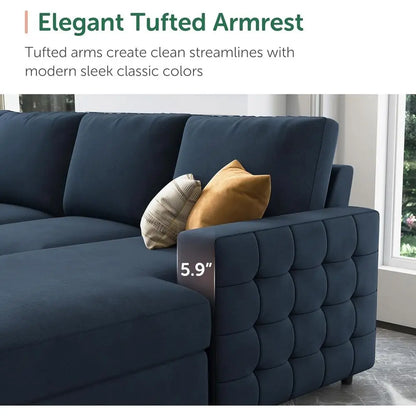Navy blue sofa with tufted armrests and decorative pillows in a room with a window.