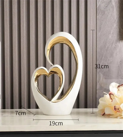 Decorative sculpture of two interlocking hearts with measurements on a neutral background