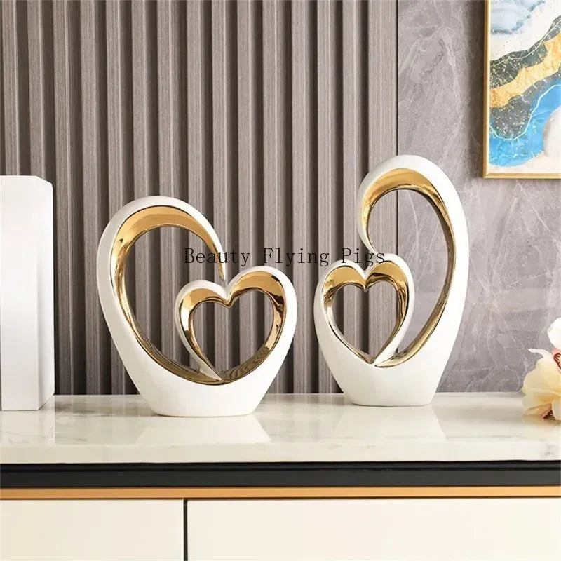 Decorative heart-shaped sculptures on a shelf with a neutral background
