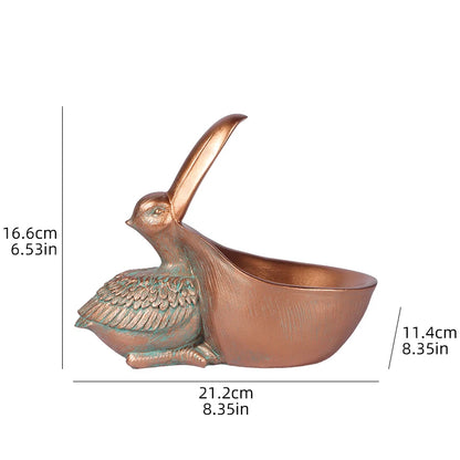 Bronze bird-shaped container with measurements on a white background