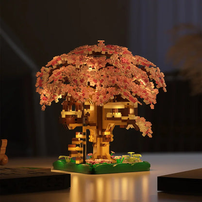 LEGO model of a cherry blossom tree with illuminated flowers on a dark background