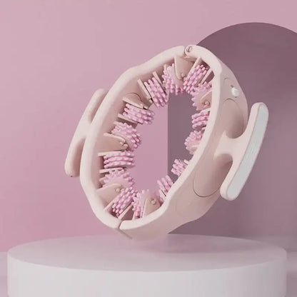 Pink handheld massager on a white platform with a pink background