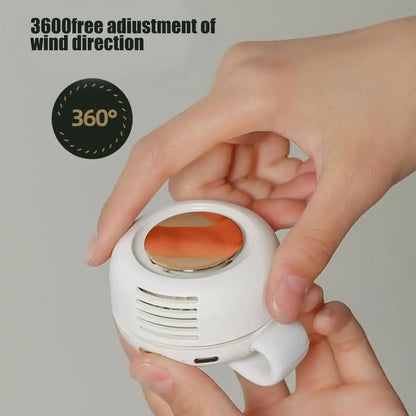 Hand holding a white Clip-On Portable Fan featuring text about wind direction adjustment.