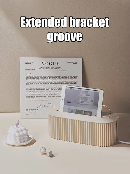 Beige electronic device with tablet on a beige surface, Vogue magazine in the background