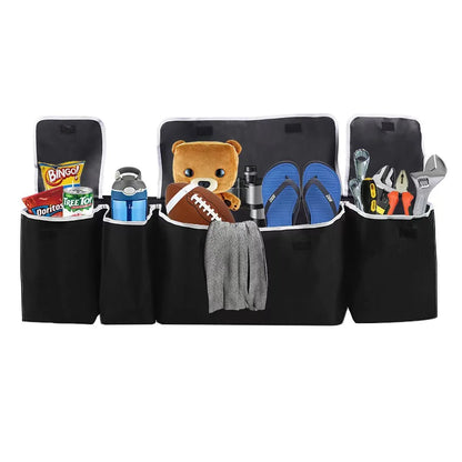 Black car organizer with various items including snacks, a teddy bear, and tools.