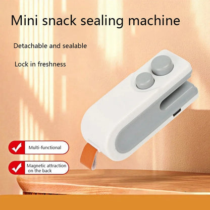 Mini snack sealing machine with text on a wooden surface