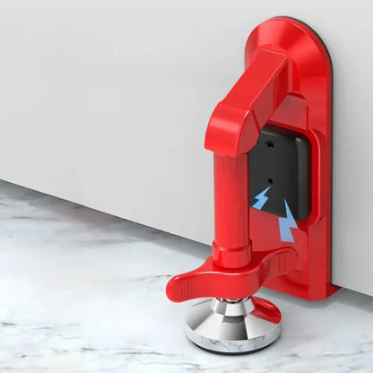 Red door stopper attached to a white door on a marble floor.