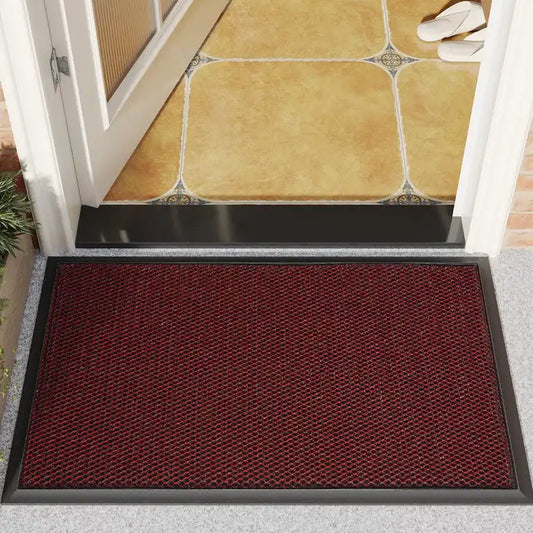 Red doormat on a gray floor with a tiled entranceway background