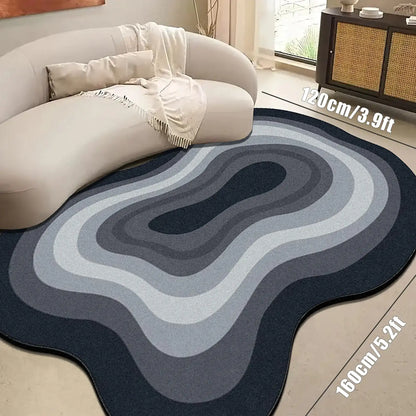 Rounded gray and blue area rug on a light wood floor with a white sofa.