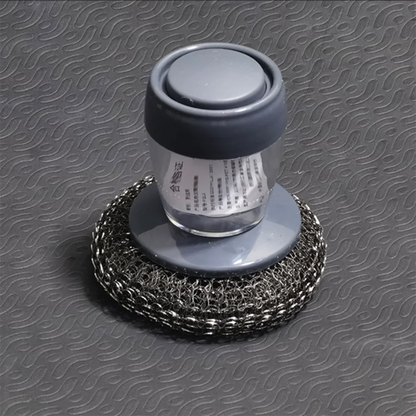 Metallic scrubber with a cylindrical handle on a textured gray background