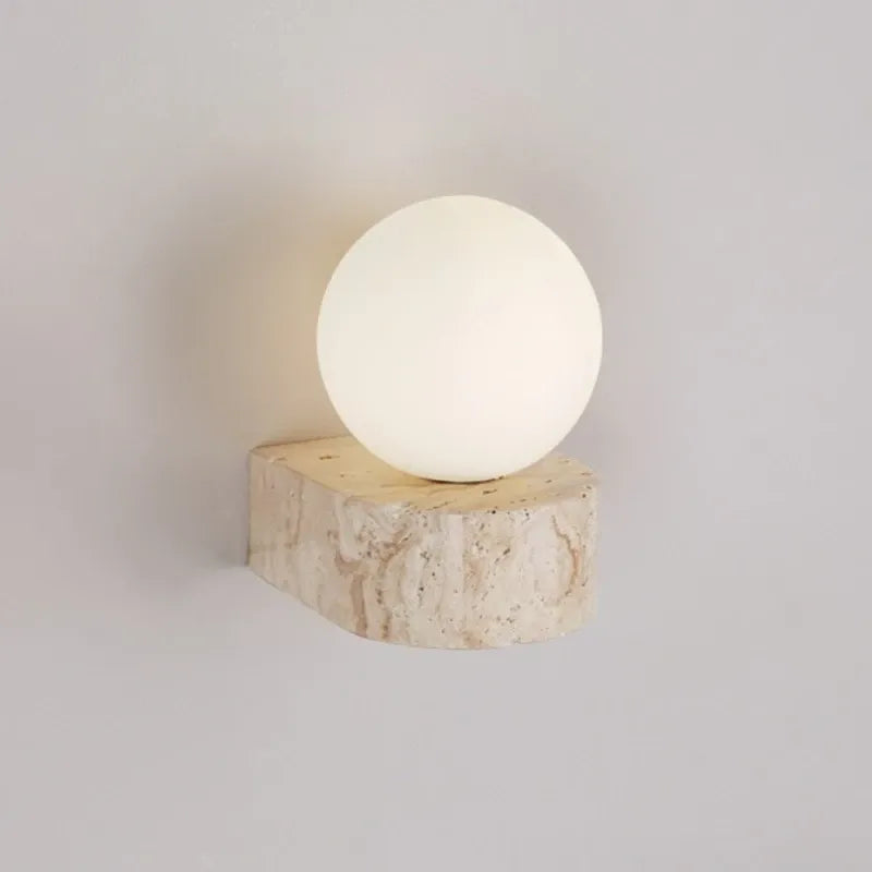 Spherical light fixture on a wooden base against a plain background