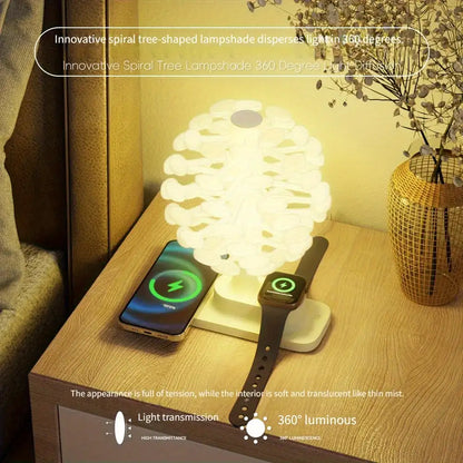 Spiral tree-shaped lampshade on a wooden surface with a phone and watch on a stand.