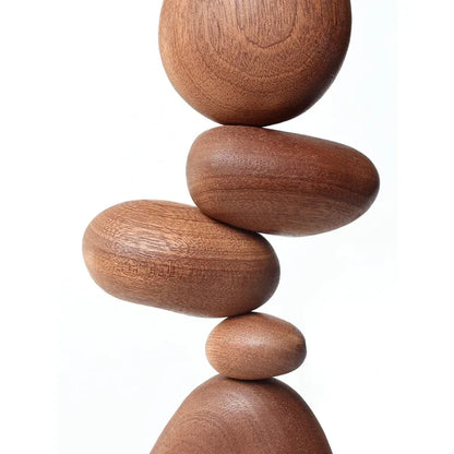 Stack of wooden spheres on a white background