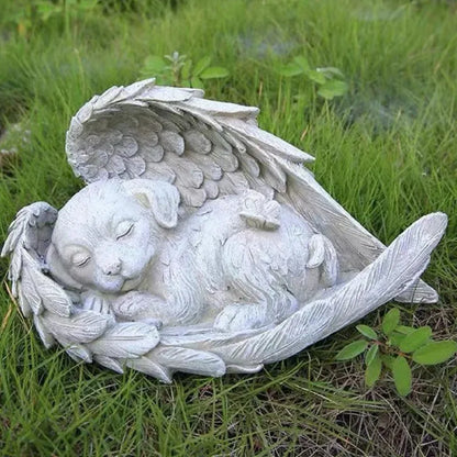 Statue of a Dog with angel wings on grass