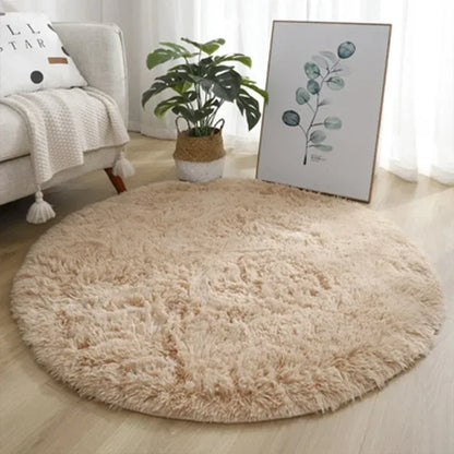 Round beige rug in a living room with a couch, plant, and artwork.