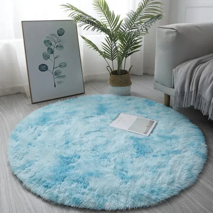 Round light blue rug in a room with a plant and framed picture on the wall.