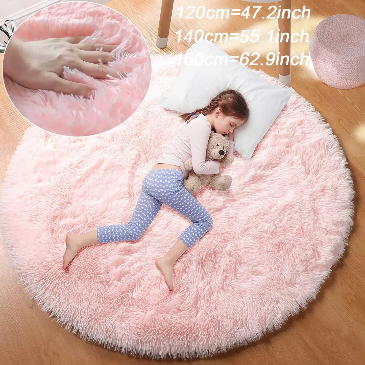 Pink fluffy rug with a child lying on it, holding a teddy bear, with measurements inset.