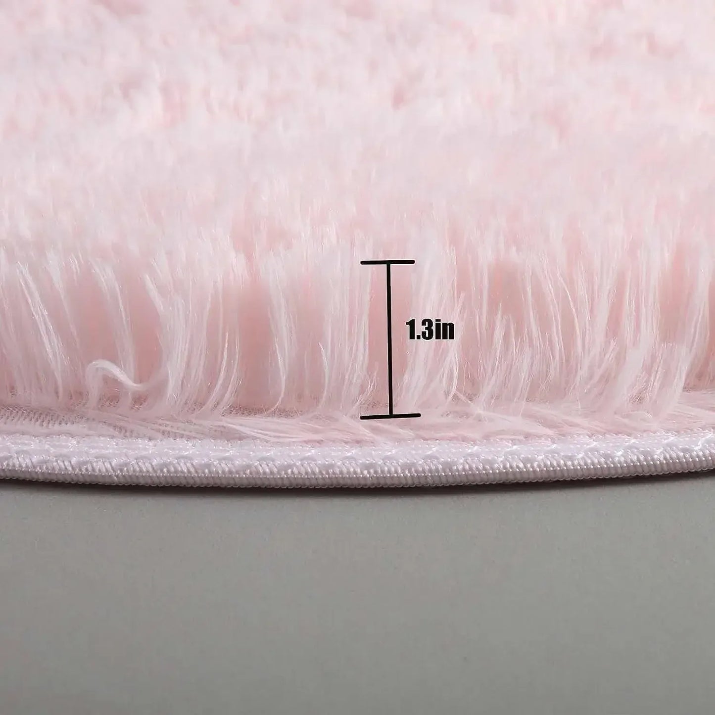 Close-up of pink fluffy material with a measurement label indicating 1.3 inches.