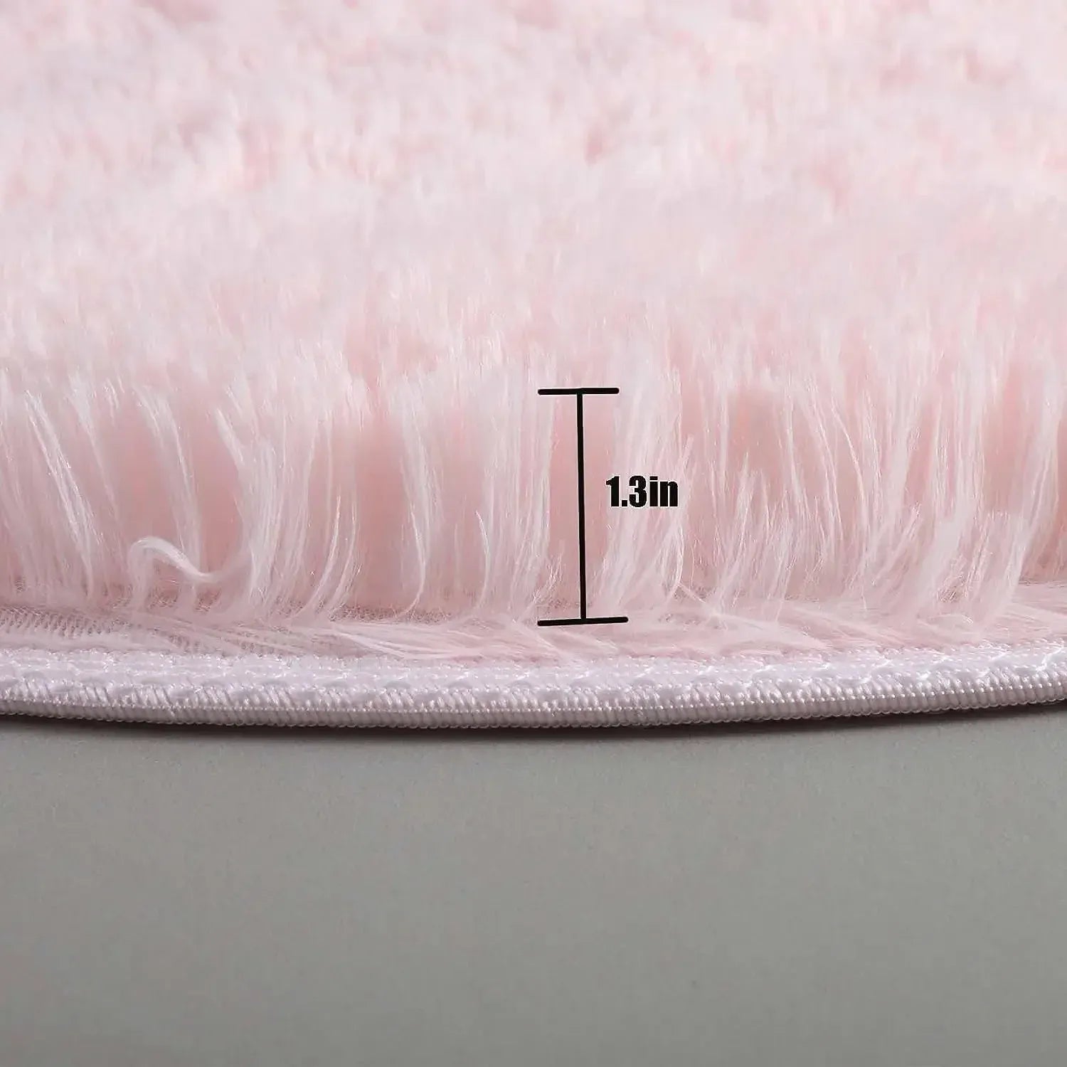Close-up of pink fluffy material with a measurement label indicating 1.3 inches.