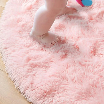 Close-up of a fluffy pink rug with a child's feet stepping onto it.