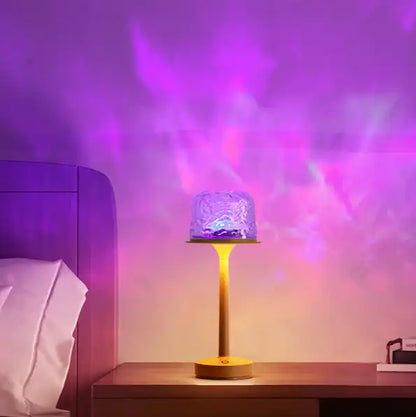 Table lamp emitting purple light on a wooden surface with a blurred background