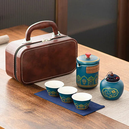 Tea set with a brown suitcase on a wooden table
