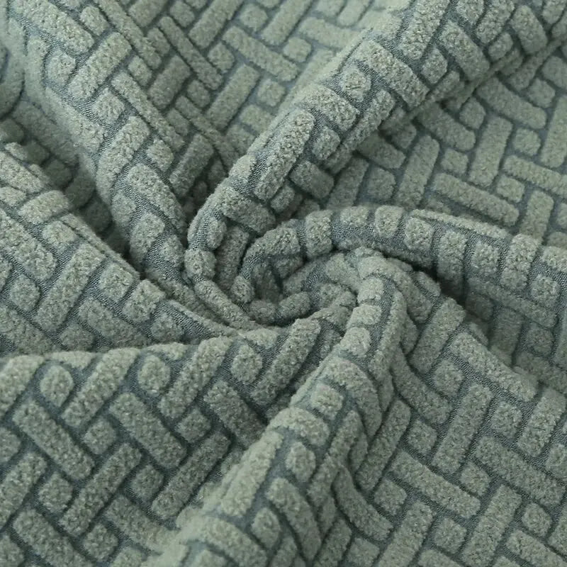 Textured green fabric with a geometric pattern