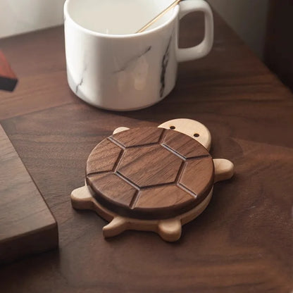 Wooden turtle coaster on a wooden surface with a white mug in the background.