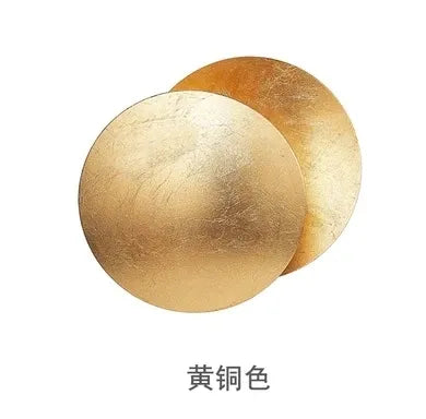 Two gold-colored  wall sconces on a white background