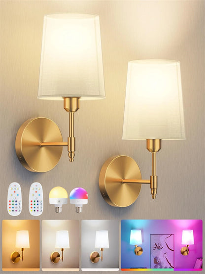 Two gold wall sconces with white lampshades on a neutral background, accompanied by LED light bulbs and remote controls.