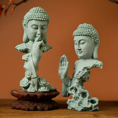 Two stone Buddha statues on wooden stands against an orange background