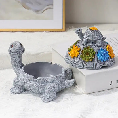 Two turtle-shaped decorative items with floral designs on a light surface.