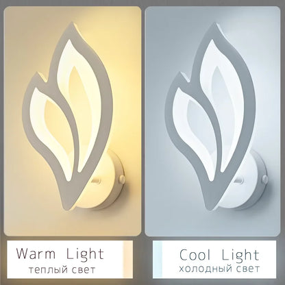 Two wall lights with leaf design, one emitting warm light and the other cool light, on a beige and gray background.