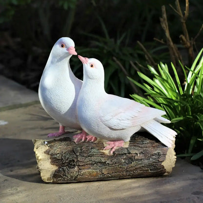 Two white doves standing on a log with greenery in the background