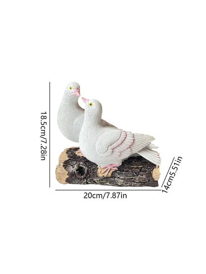 Two white pigeon figurines on a branch with measurements indicated.