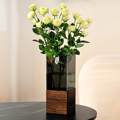 Vase with green flowers on a table against a neutral background