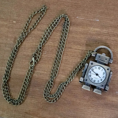 Vintage pocket watch with chain on a wooden surface