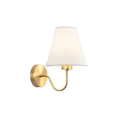 Wall-mounted lamp with white shade and gold arm on a white background