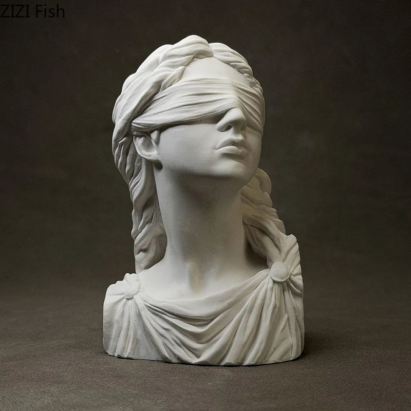 White marble bust of a woman with a blindfold on a dark background