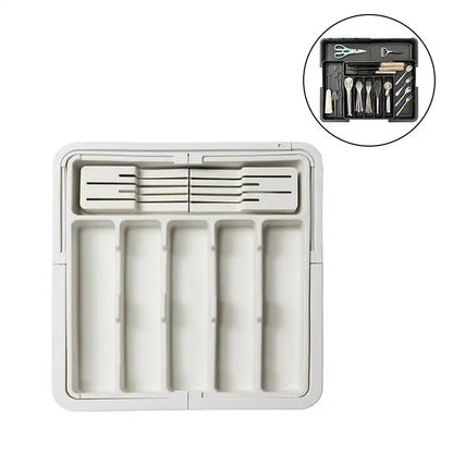 White kitchen drawer organizer with cutlery and tools on a white background