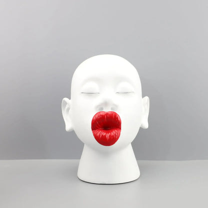 White mannequin head with red lips on a gray background