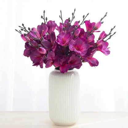 White vase with purple flowers on a white background