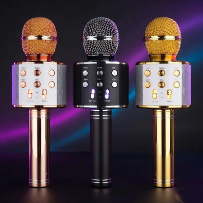 Three wireless microphones with different colored mics on a dark background