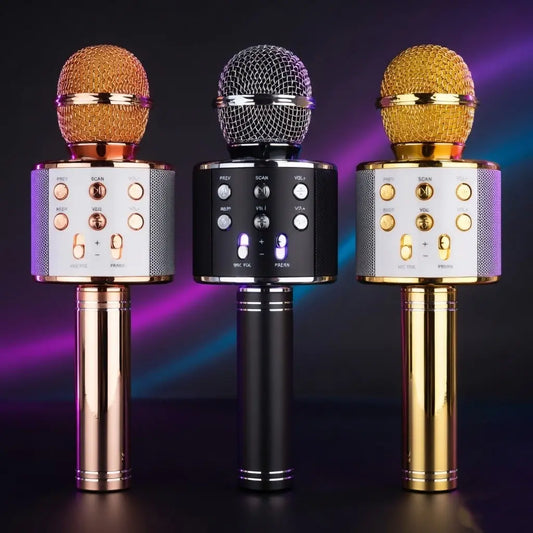Three wireless microphones with different colored mics on a dark background