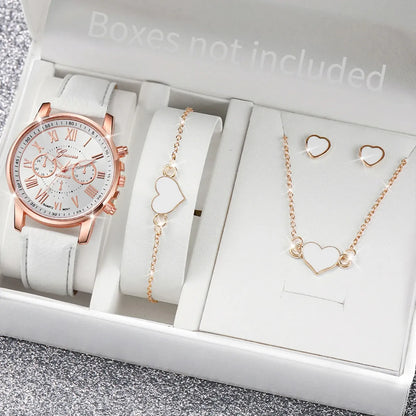 Rose gold watch and jewelry set with heart designs on a gray surface
