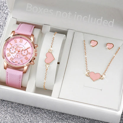 Pink watch and jewelry set with heart designs on a gray surface