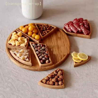 Wooden charcuterie board with various snacks on a light gray surface